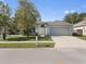 Charming single-story home with a well-manicured lawn and attached garage at 464 Dominish Estates Dr, Apopka, FL 32712