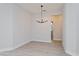 Minimalist dining room with light wood-look flooring, a modern chandelier, and neutral paint at 5097 Grand Teton Ct, Deland, FL 32724