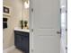 Modern bathroom with navy vanity, white countertops, and decorative plants at 5306 Marshelder St, Apopka, FL 32712