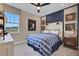 Well-lit bedroom featuring baseball themed decor, a ceiling fan, and a bright window at 5306 Marshelder St, Apopka, FL 32712