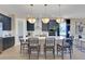 Modern kitchen with navy cabinetry, white countertops, and a large island with seating at 5306 Marshelder St, Apopka, FL 32712