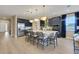 Expansive kitchen featuring a large island, pendant lights, stainless steel fridge, and navy cabinets at 5306 Marshelder St, Apopka, FL 32712