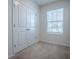 Bright bedroom with a double door closet, plush carpet, and a sunlit window at 5391 Dragonfly Dr, Wildwood, FL 34785