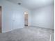 Carpeted bedroom with a closet and a doorway to the bathroom at 5391 Dragonfly Dr, Wildwood, FL 34785