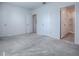 Spacious carpeted bedroom with white walls and doors leading to closets and bathroom at 5391 Dragonfly Dr, Wildwood, FL 34785