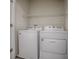 Clean laundry room features new washer and dryer, and overhead storage shelf at 5391 Dragonfly Dr, Wildwood, FL 34785