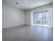 Bright living room with sliding glass doors to the patio and tile floors at 5391 Dragonfly Dr, Wildwood, FL 34785