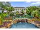 Stunning exterior view of the building with well-manicured grounds, waterfall and a charming bridge at 5428 Tangelo St, Leesburg, FL 34748