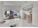 Bright sunroom features white tile flooring and sliding glass doors to the main bedroom at 5428 Tangelo St, Leesburg, FL 34748