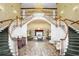 Elegant lobby featuring a grand staircase, chandelier, and seating area at 5428 Tangelo St, Leesburg, FL 34748