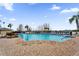 Large community pool surrounded by lounge chairs and manicured landscaping on a sunny day at 5428 Tangelo St, Leesburg, FL 34748