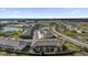 Aerial view of newly built townhomes, nestled by serene ponds and lush landscapes, creating a peaceful community setting at 5435 Dragonfly Dr, Wildwood, FL 34785