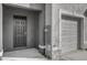 Close-up of the gray front door with a single-car garage entrance at 5435 Dragonfly Dr, Wildwood, FL 34785