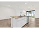 Bright kitchen island with granite countertops, stainless steel dishwasher and wood-style floors at 5435 Dragonfly Dr, Wildwood, FL 34785