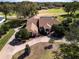 An aerial view of a grand home on a large lot backing onto a green golf course and lake at 5746 Crestview Dr, Lady Lake, FL 32159