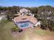 Aerial view of house with a screened pool surrounded by mature trees and well-maintained landscaping at 5746 Crestview Dr, Lady Lake, FL 32159