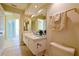 Bright bathroom with double sinks, a large mirror, and neutral tiling at 5746 Crestview Dr, Lady Lake, FL 32159