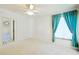 Bedroom featuring neutral walls, white carpet, a ceiling fan, and a large window at 5746 Crestview Dr, Lady Lake, FL 32159