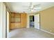 Bedroom features built-in wooden shelves and cabinets, complemented by neutral paint, and a ceiling fan at 5746 Crestview Dr, Lady Lake, FL 32159