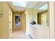 Hallway with tile flooring, and a built-in cabinet with large mirror on top, adds style and functionality at 5746 Crestview Dr, Lady Lake, FL 32159