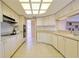 Bright kitchen featuring all white cabinetry, neutral countertops, tile flooring, and a unique coffered ceiling at 5746 Crestview Dr, Lady Lake, FL 32159