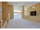 Open-concept living room with chandelier, built-in shelving and views of the home's bright, open floor plan at 5746 Crestview Dr, Lady Lake, FL 32159