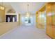 Bright living room with a chandelier, built-in shelving, and a clear view of the front entrance and lush landscaping at 5746 Crestview Dr, Lady Lake, FL 32159