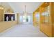 Bright living room featuring a chandelier, built-in shelving and plenty of natural light from the large window at 5746 Crestview Dr, Lady Lake, FL 32159