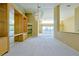 Bright living room with chandelier, built-in shelving, and an open view of the home's entry and outdoor pool area at 5746 Crestview Dr, Lady Lake, FL 32159