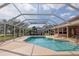 Private screened-in pool area with a spacious patio, ideal for swimming, lounging, and entertaining guests at 5746 Crestview Dr, Lady Lake, FL 32159