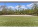 A large, turfed backyard awaits personalization in this shot from under the covered porch at 68 Malauka Pass Crse, Ocklawaha, FL 32179