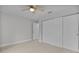 Bedroom with plank flooring, ceiling fan, closet, and neutral walls at 68 Malauka Pass Crse, Ocklawaha, FL 32179