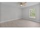 Bright bedroom with a ceiling fan, light-colored walls, and wood-look floors at 68 Malauka Pass Crse, Ocklawaha, FL 32179