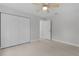 Bedroom with plank flooring, a ceiling fan, closet, and neutral walls at 68 Malauka Pass Crse, Ocklawaha, FL 32179