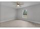 Bedroom features a large window bringing the outdoors in, plank flooring and neutral-toned walls at 68 Malauka Pass Crse, Ocklawaha, FL 32179