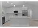 Modern kitchen with white cabinetry, stainless steel appliances, and a central island at 68 Malauka Pass Crse, Ocklawaha, FL 32179