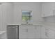 Bright kitchen featuring white cabinets, stainless steel appliances, and a window view at 68 Malauka Pass Crse, Ocklawaha, FL 32179