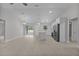 Bright and airy living room with a seamless transition to the modern kitchen and outdoor access at 68 Malauka Pass Crse, Ocklawaha, FL 32179