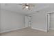 Spacious main bedroom with tray ceiling, ceiling fan, and ensuite bathroom at 68 Malauka Pass Crse, Ocklawaha, FL 32179