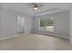 Bright main bedroom featuring a tray ceiling and a view to the backyard at 68 Malauka Pass Crse, Ocklawaha, FL 32179