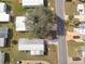 Aerial view of a manufactured home with metal roof, a unique compass-rose driveway, and mature landscaping at 730 Royal Palm Ave, The Villages, FL 32159