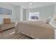 Light and airy bedroom with wood-look floors, a queen bed, and a window for plenty of natural light at 730 Royal Palm Ave, The Villages, FL 32159