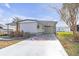 Inviting exterior with a carport featuring a unique compass rose design on the driveway at 730 Royal Palm Ave, The Villages, FL 32159