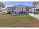 Charming home with a well-manicured lawn, carport, and inviting front porch at 730 Royal Palm Ave, The Villages, FL 32159