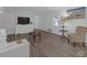 Living room featuring wood-look flooring, neutral paint, natural light, and comfortable furnishings at 730 Royal Palm Ave, The Villages, FL 32159