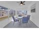 Enclosed sunroom featuring tile flooring, ceiling fan, furniture, and bright natural lighting at 730 Royal Palm Ave, The Villages, FL 32159