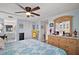 Bright main bedroom with hardwood floors, blue walls, and view into the main bathroom at 8 Gallinule Ct, Fruitland Park, FL 34731