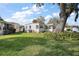 View of the home surrounded by a green, well-manicured lawn at 8 Gallinule Ct, Fruitland Park, FL 34731