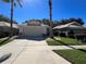 A wide shot of the home and driveway shows a charming single-story with mature landscaping at 8004 Saint Andrews Way, Mount Dora, FL 32757