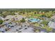 Overhead view of a large clubhouse with a sprawling outdoor pool and manicured green spaces at 8660 Se 132Nd Ln, Summerfield, FL 34491